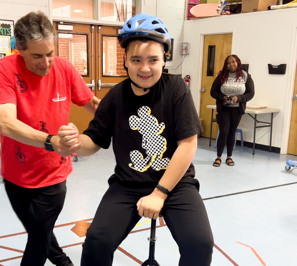 A student practices using a Just Balance unicycle