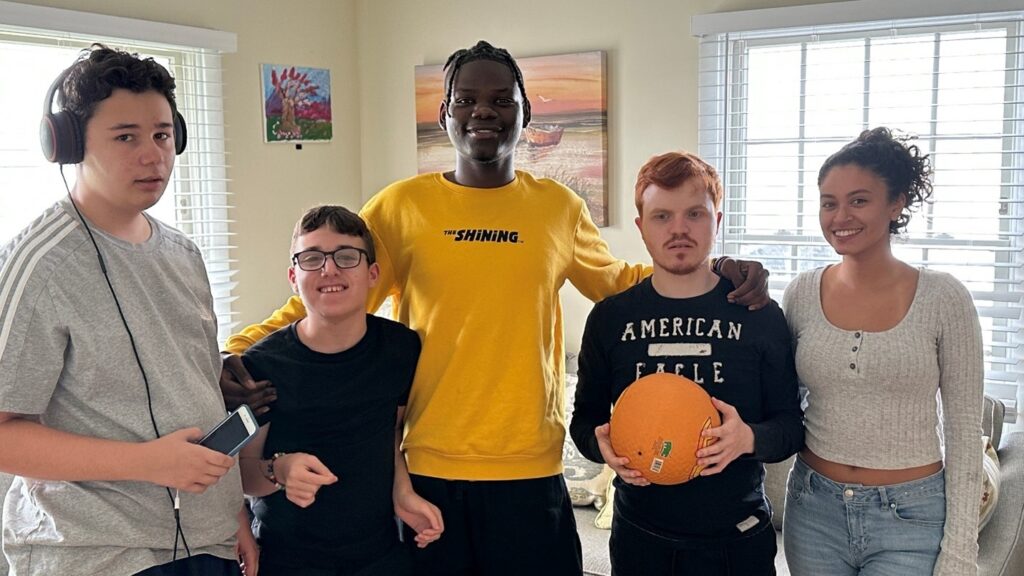 Residents, staff and families pose for a photo in celebration of CRP Day