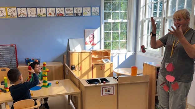 Post Avenue teacher Teacher Concepta “Connie” Neylon-Lorick shows students how to celebrate fall