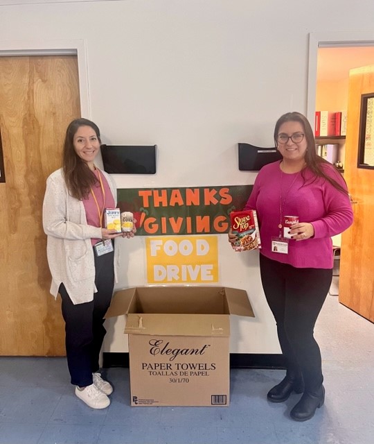 BCCS staff pose with their food drive to address food insecurity