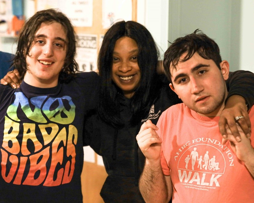 A photo of Shauntee Dunn with two of the children she works with