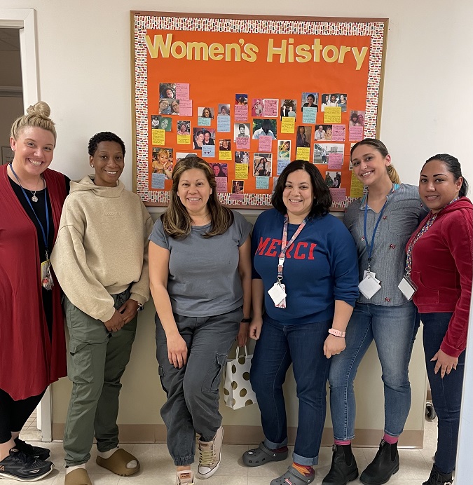 BCCS DEI poses with their Women's History Board