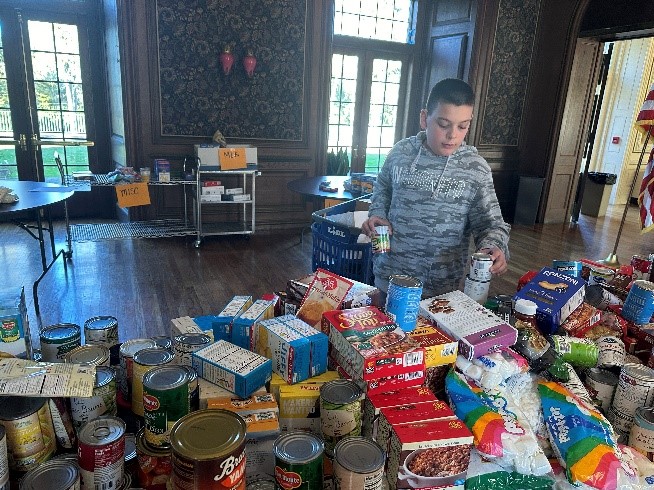 A BCCS student sorts food for the Thanksgiving food drive