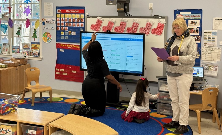 Post Avenue teachers and a student enjoying the virtual holiday concert.