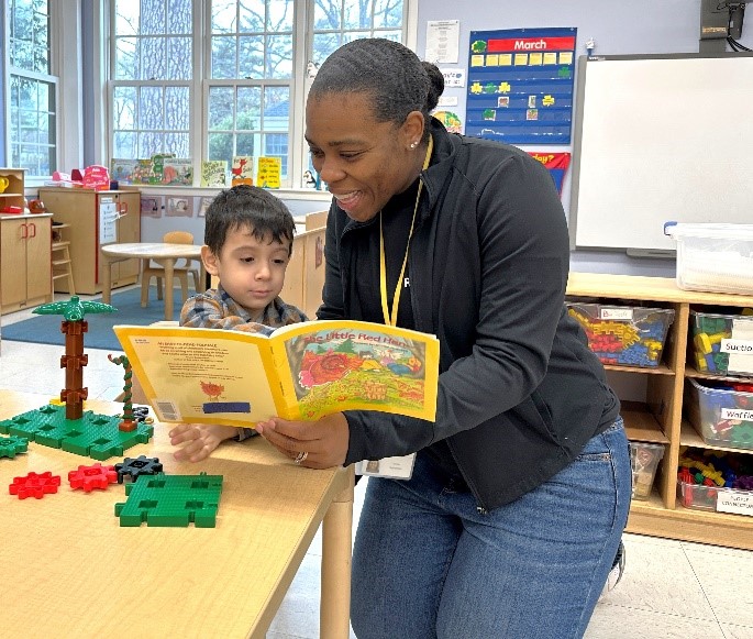 Special Education Teacher Cynthia Tanis-Innocent reading with a student.