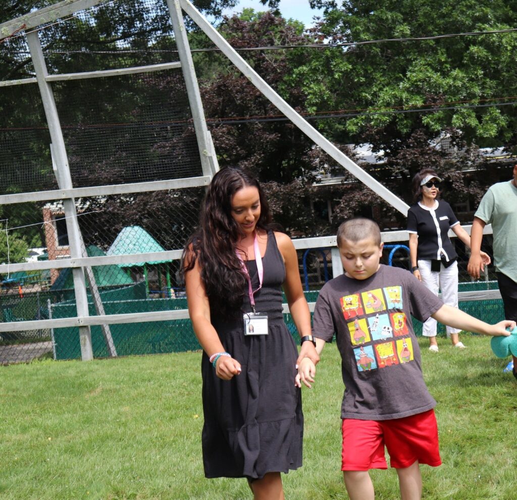 An Education Center teacher guides a student during Fun Friday