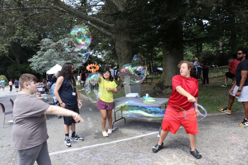 Children's Education Center students play with bubbles at the block party.
