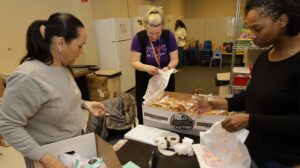 Three Round Hill Road PA members gather pretzels for the pretzel sale.