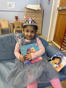 A Post Avenue student dressed up like a princess as she holds her favorite book for Spirit Week.