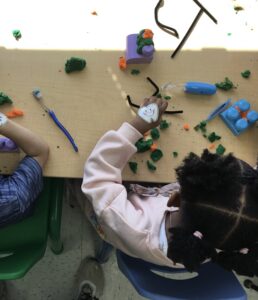 A Round Hill Road student plays with LEGO and Play-Doh, representing teeth cleaning.