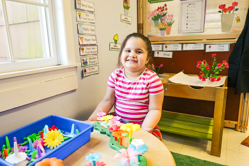 A Post Avenue student plays with the toy flower shop.