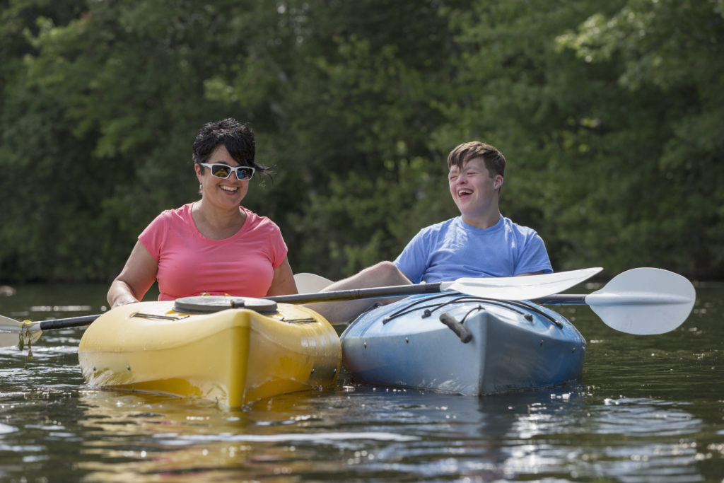 young boy with staff kayaking Brookville Center