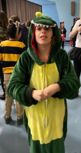 Student celebrates in dinosaur costume