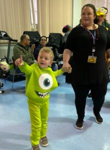 A preschooler dressed as a monster arrives