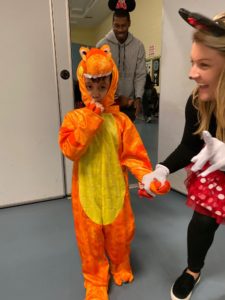Student dressed as dinosaur enters party with teacher dressed as Minnie Mouse