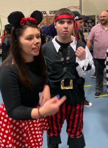 Teacher dressed as Minnie Mouse and student dressed as a pirate enjoy the festitvities