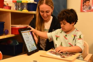 B Teacher And Ipad | Brookville Center teacher and student with ipad