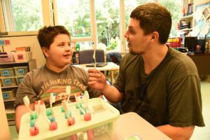 boy and teacher with toothbrushes