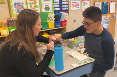 Amy Kelly Works With Student