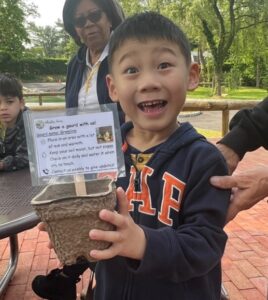 A BCCS Student shows off his plant for the Harvest Festival