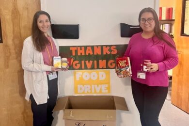 BCCS staff pose with their food drive to address food insecurity
