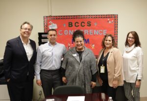 Assemblywoman Gina Sillitti poses with BCCS staff at holiday cookie decorating event