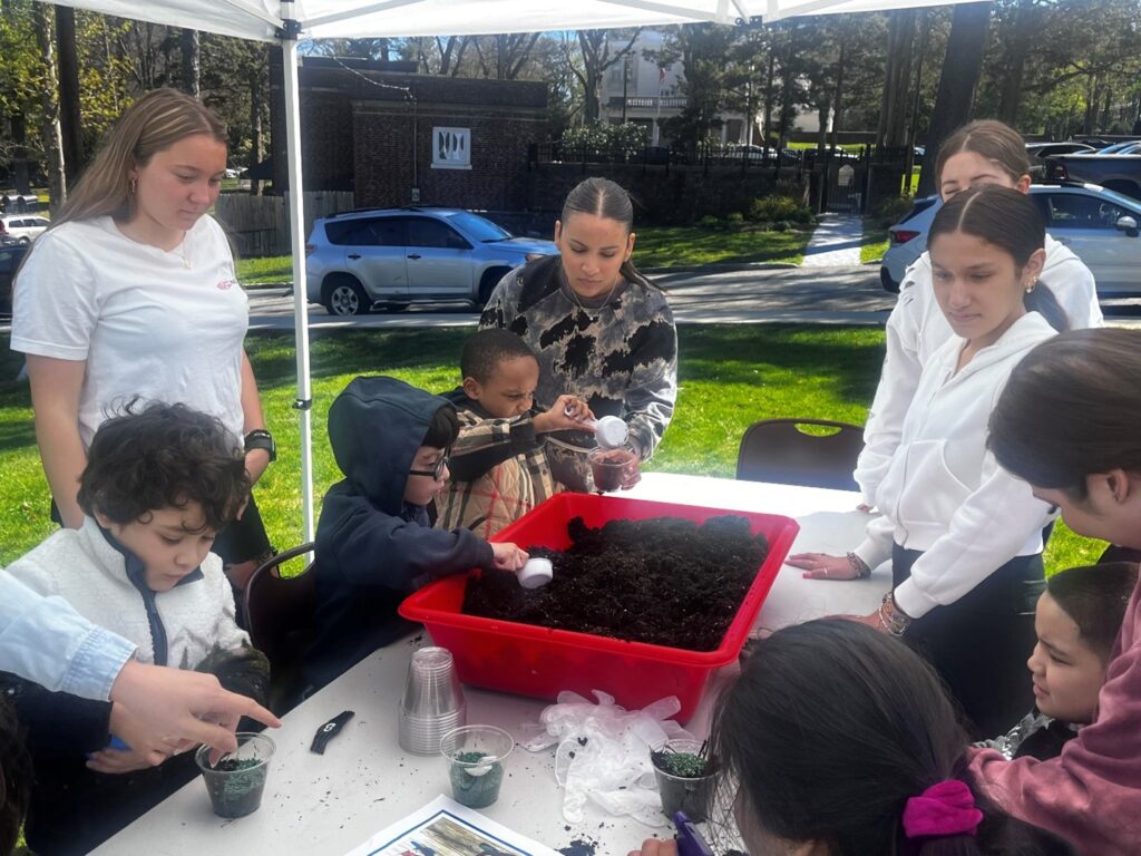 Lynbrook High School and BCCS students plant grass together in celebration of Earth Day