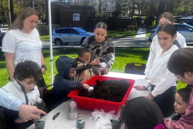 Lynbrook High School and BCCS students plant grass together in celebration of Earth Day