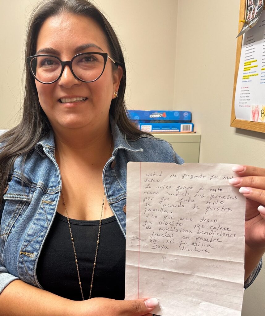 Vanessa Martinez-Mautino with a letter written to her from a family she helped