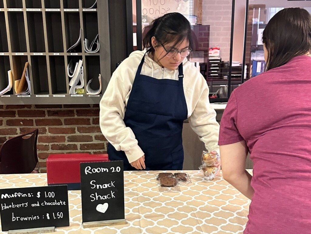 A Brookville Center for Children’s Services student sells snacks at the Snack Shack