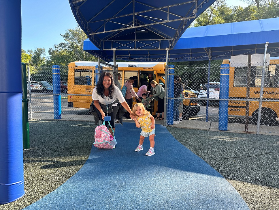 A BCCS teacher helps a student off the bus