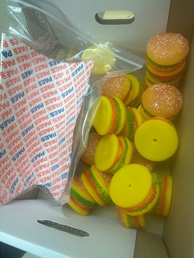 A box filled with prop hamburgers that will be used in the PAES lab for food service training