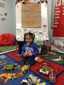 A student of Special Education teacher Jamie Schantz smiles in her classrom