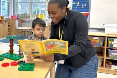 Special Education Teacher Cynthia Tanis-Innocent reading with a student.
