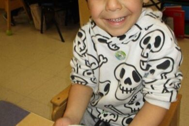 A BCCS preschool student with his plate of pasta and sauce during Food Week.