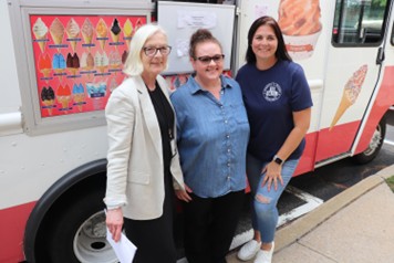 Three BCCS teachers in front of one of the ice cream trucks.