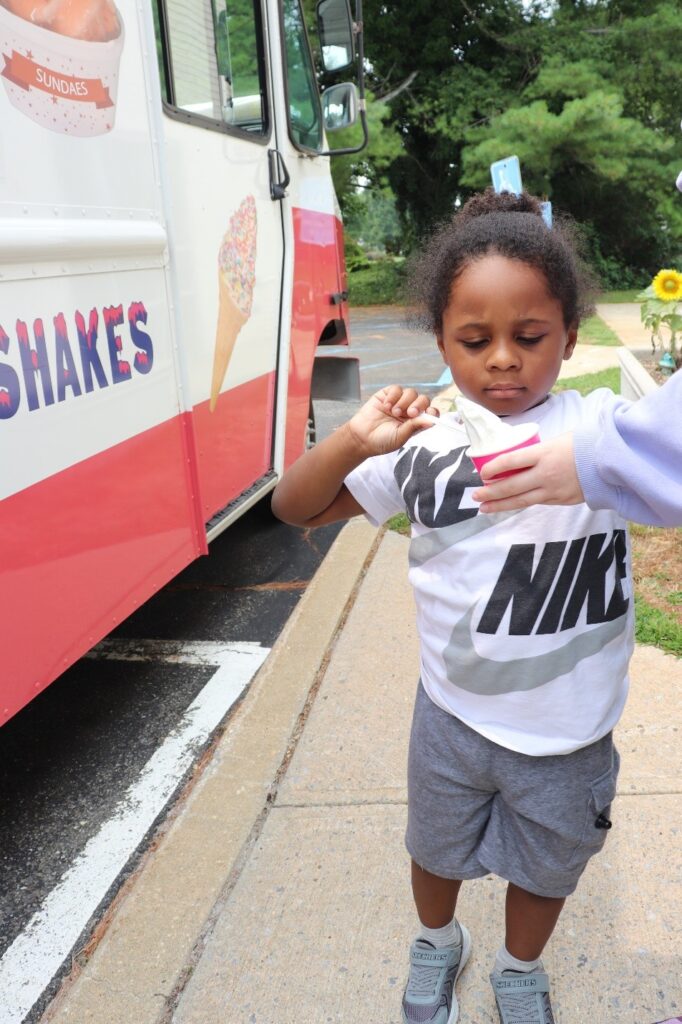 A BCCS student enjoys ice cream from an ice cream truck.