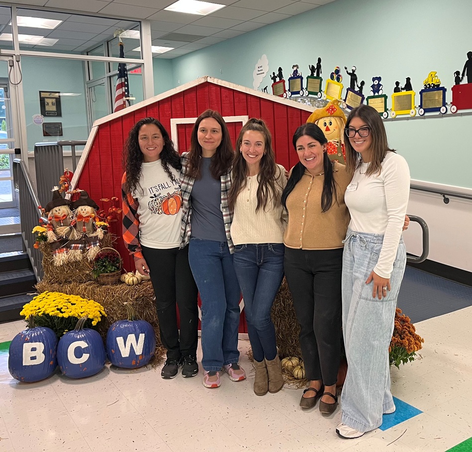 Five Barbara C. Wilson staff in front of fall decor at Fall Harvest Day