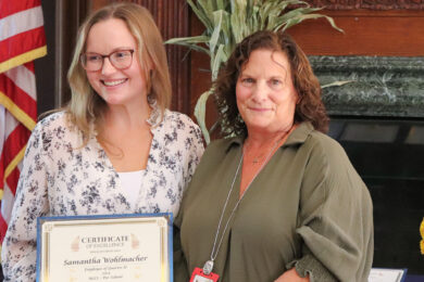 Samantha Wohlmacher is presented with the Employee of the Quarter award.