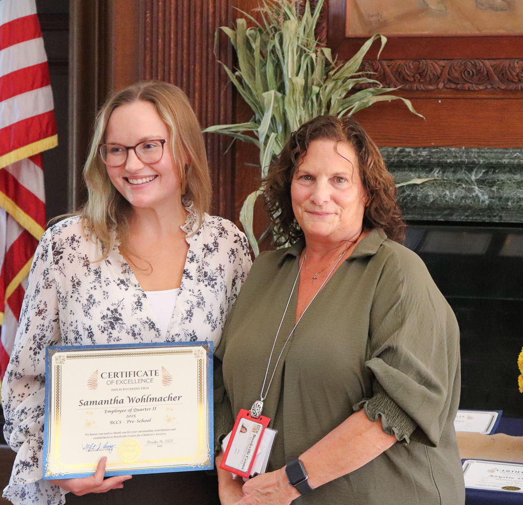 Samantha Wohlmacher is presented with the Employee of the Quarter award.