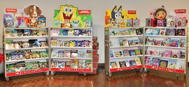 Four display stands of books at the book fair.