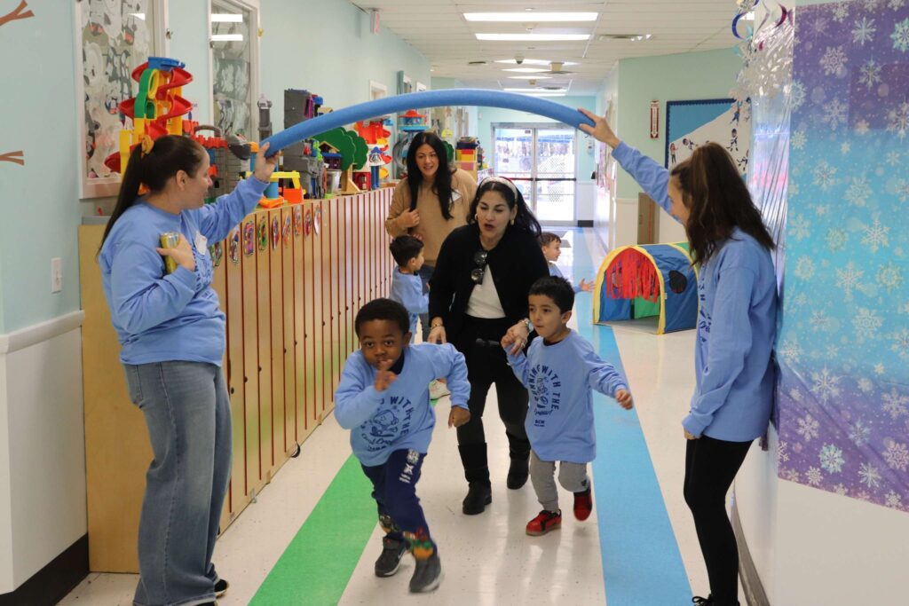 Teachers help BCW students do an obstacle course in honor of the Winter Olympics