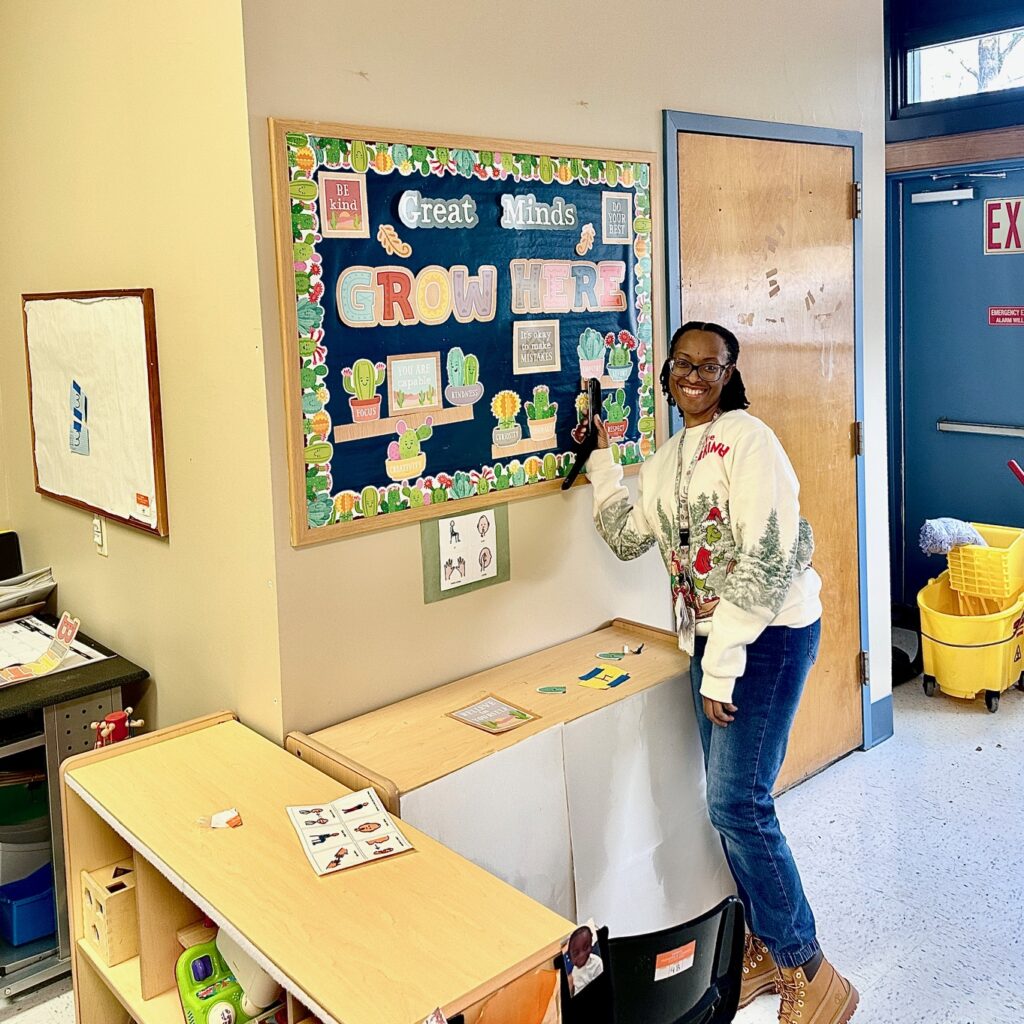 A teacher at Round Hill Road school points to the display she created in her new classroom.